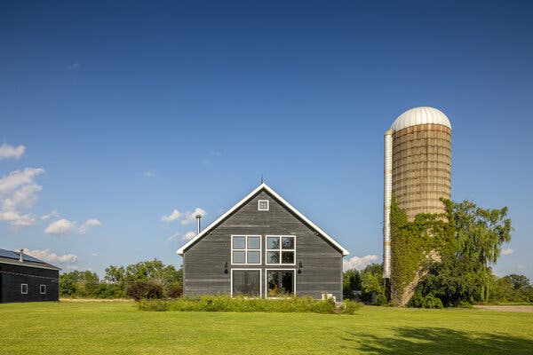 The interior of a converted barn, now a stylish and comfortable living space with modern amenities.