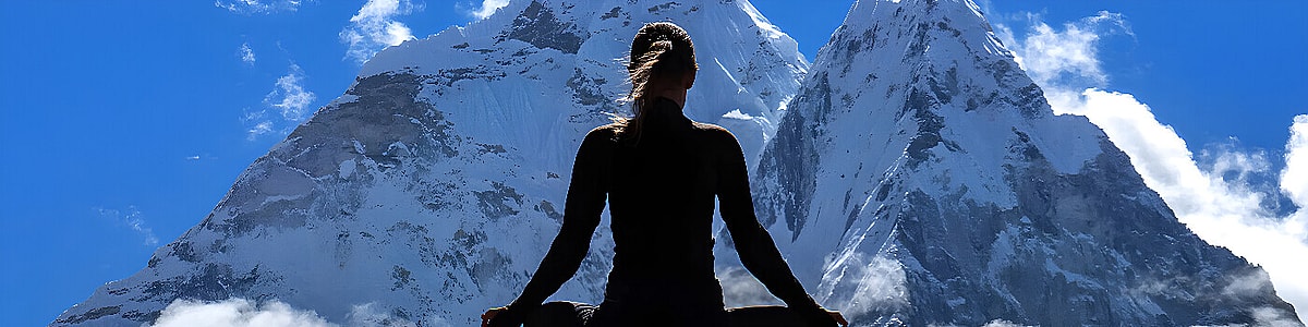 A person doing yoga in the snow in Lapland, silhouetted against the Northern Lights