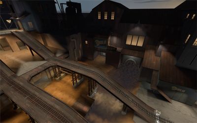 A Demoman setting a sticky bomb trap near a control point, showcasing area denial tactics.