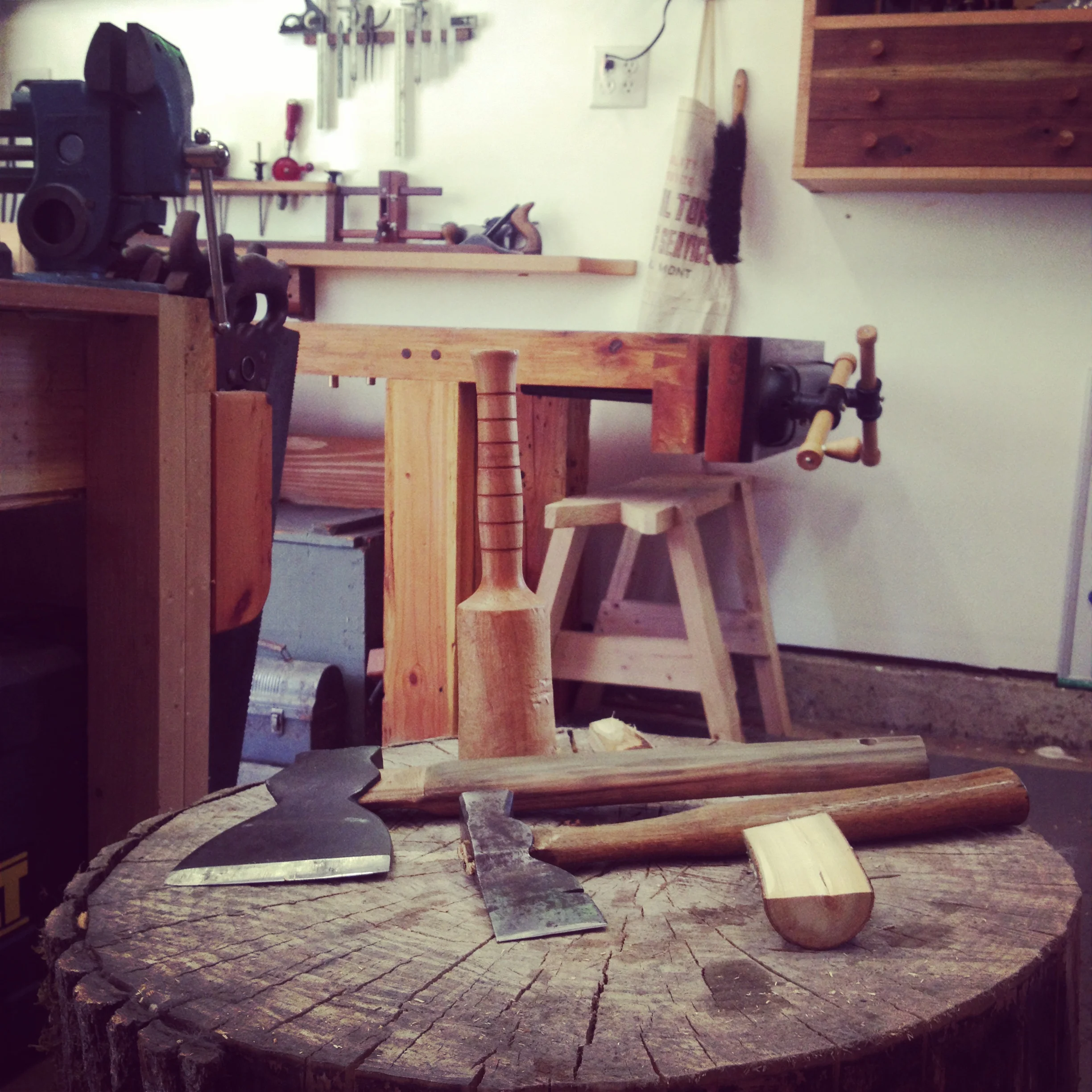 Well-organized workbench with various hand tools, cleaning supplies, and fasteners