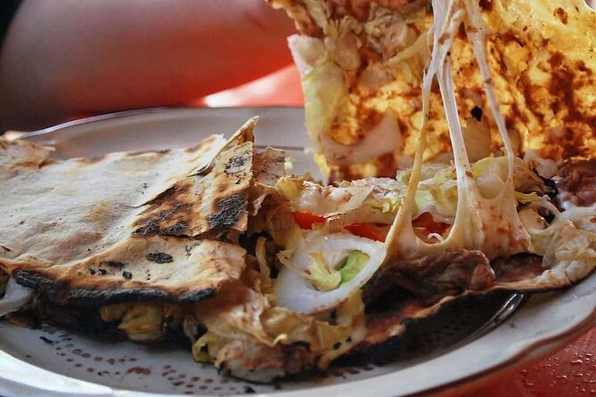 A vibrant photo capturing the sights, sounds, and smells of the bustling street food scene at Mercado 20 de Noviembre in Oaxaca.