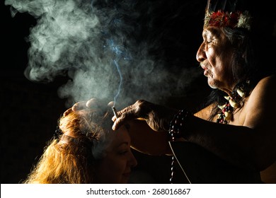 A close-up shot of the shaman's hands during the medicinal plant ceremony, highlighting his aged skin and traditional bracelets, symbolizing the wisdom and connection to the Amazonian culture
