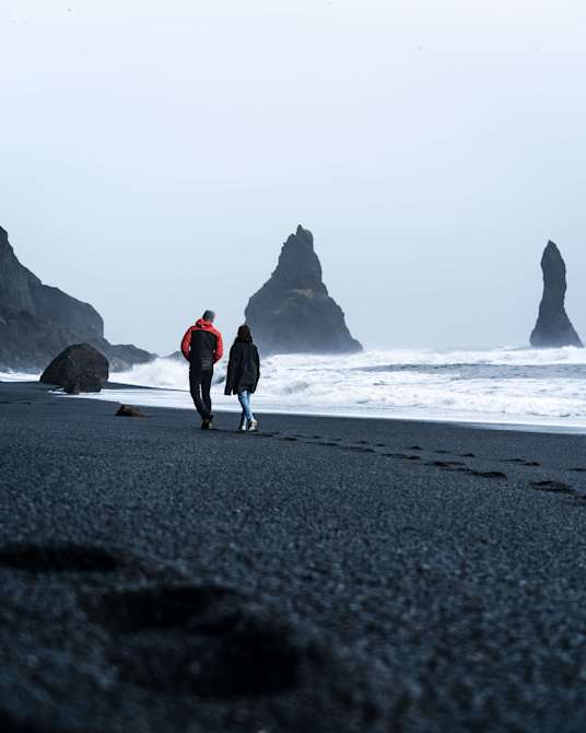 Basalt columns and crashing waves at Reynisfjara Beach, Iceland.