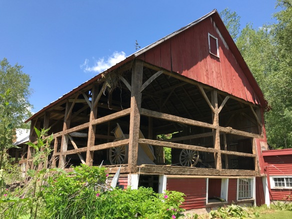 Barn siding being removed, revealing the underlying structure.