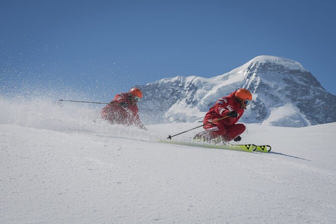 A group of people snowmobiling through a snowy, mountainous landscape, showcasing the excitement of the activity