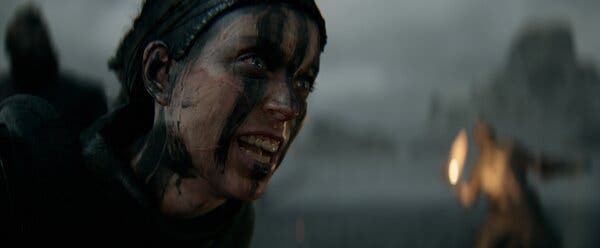 A haunting, close-up of Senua, highlighting the textures and details of her face and hair, immersing players into her experience of psychological turmoil.