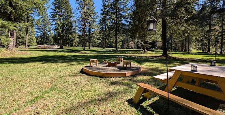 Family campsite with tent, picnic table, and supplies