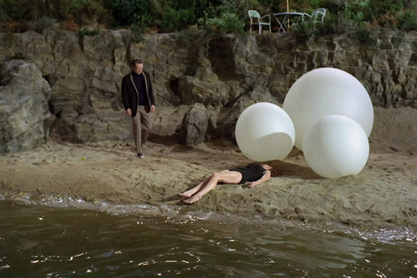 A still from The Prisoner showing Number Six defiantly facing the Rover, showcasing his struggle against control and authority