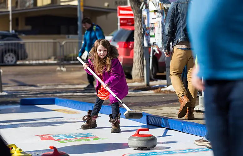 A photo of bannock bread being cooked over a fire during the Indigenous snowshoeing tour, capturing the warmth and authenticity of the experience