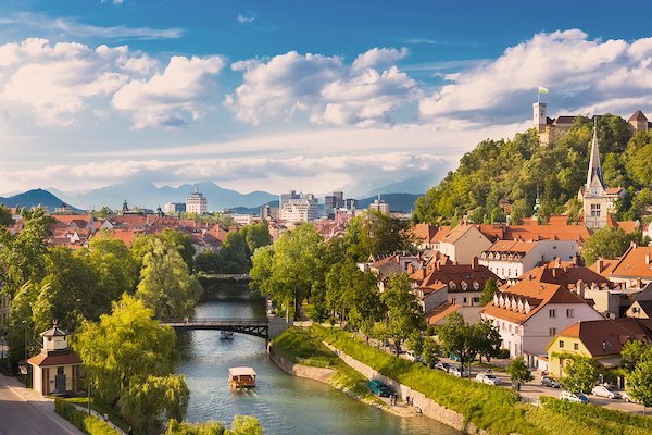 View of Lake Bled with the island church during sunset with the Julian Alps in the distance