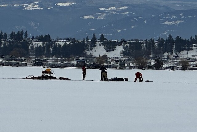 An Indigenous guide shows tourists how to ice fish on Lake Okanagan.