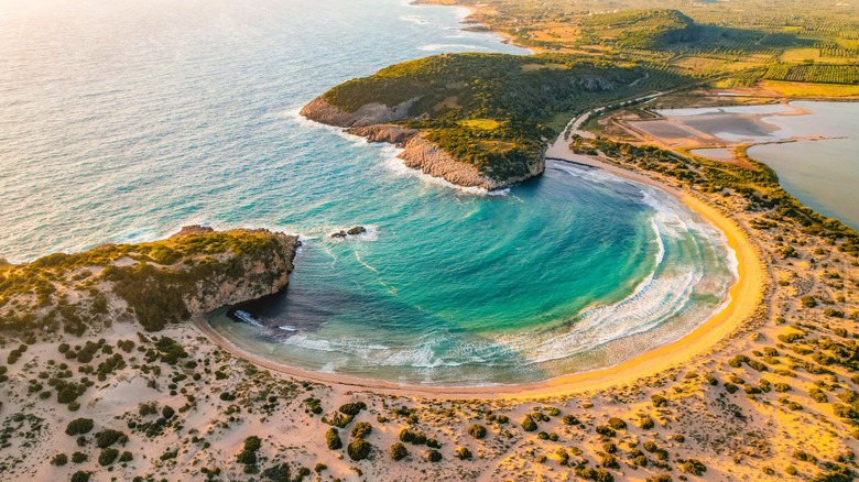 The iconic archway of Cathedral Cove, framing the distant sea stacks and the serene coastline.