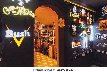 The historic Markt Square in Bruges at twilight, with the illuminated Belfry and colorful buildings creating a magical atmosphere