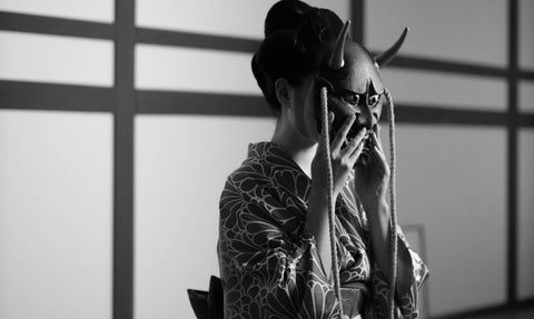 Close-up of Dr. Vance practicing calligraphy, highlighting the brushstrokes and the ink on the paper.