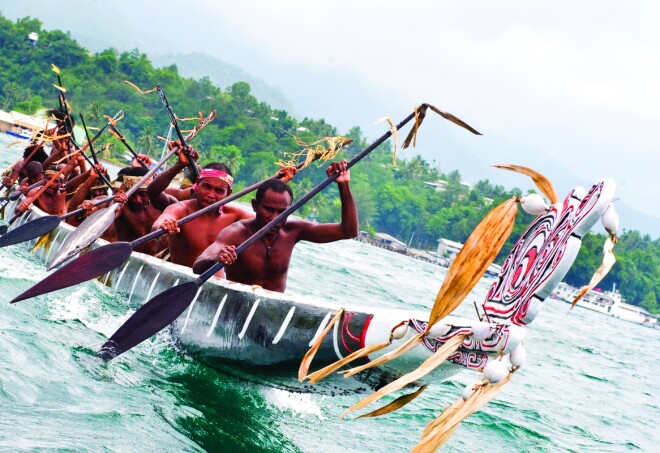 Paxon Kaliopi demonstrating traditional canoe building techniques