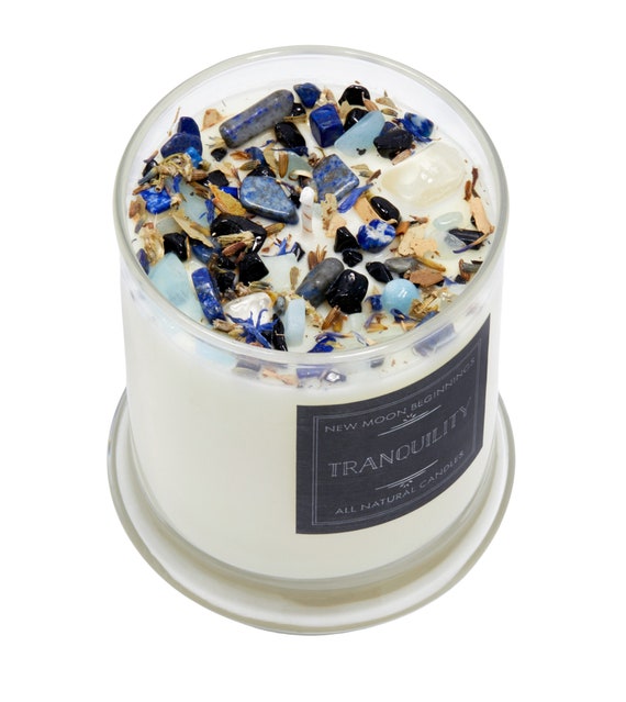 A mason jar being prepared with a candle wick secured at the bottom