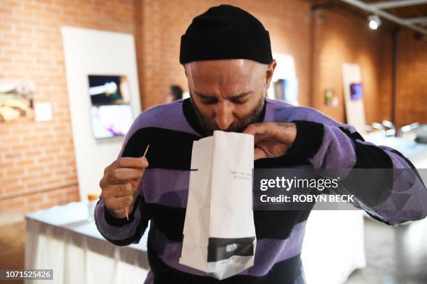 Blake triumphantly posing with an ice axe, but with his helmet on backwards.