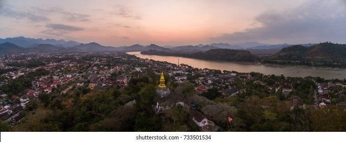 Hands preparing Mok Pa in a cooking class, with a Lao chef guiding, simulating a cozy kitchen environment