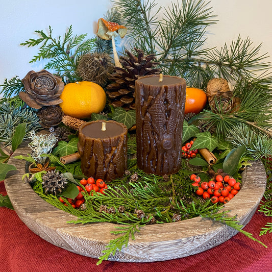 Image of the Yule Log burning in a fireplace, with flames enveloping the birch bark and casting warm light.