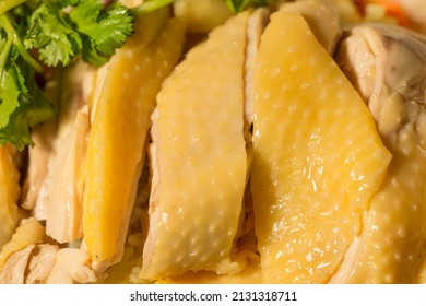 A close-up of Hainanese chicken rice, showcasing the silky chicken and fragrant rice.