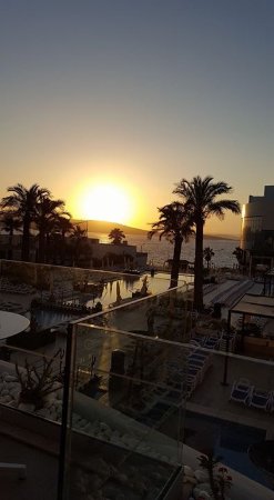 Hotel Emma room with exposed brick, modern furniture, and cocktail kit visible