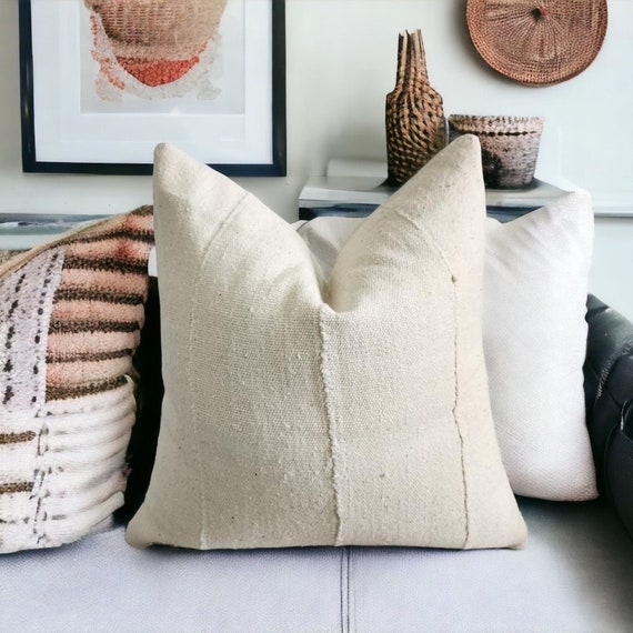 Woven baskets of various sizes arranged under a console table, providing storage and adding texture to the room.