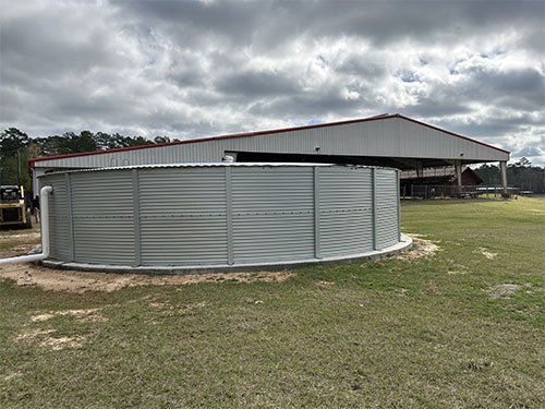 A person carefully cleans the inside of a rainwater tank to ensure it is free of debris and contaminants.