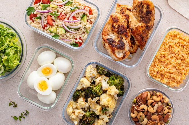 Laptop showing website and a notebook