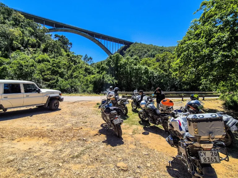 Legzira Beach in Morocco, capturing the dramatic coastline with the iconic arch remnant against the backdrop of the Atlantic Ocean and the setting sun.