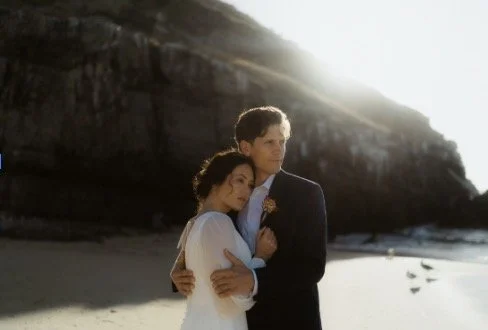 Hidden cove accessible by a wooden staircase, bathed in golden sunlight at sunset