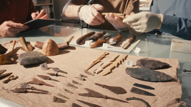 Illustration of a materials scientist working in a lab, examining ceramic samples.
