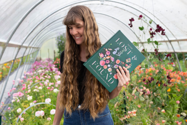 A lush vegetable garden with various plants, including flowers interspersed to attract pollinators and beneficial insects