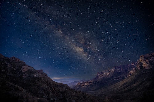 Nighttime shot of the Milky Way over the park, with Javier silhouetted in the foreground