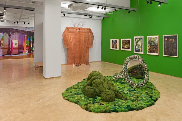 A close-up of a detailed, mechanical structure, set in a dimly lit, gritty environment.