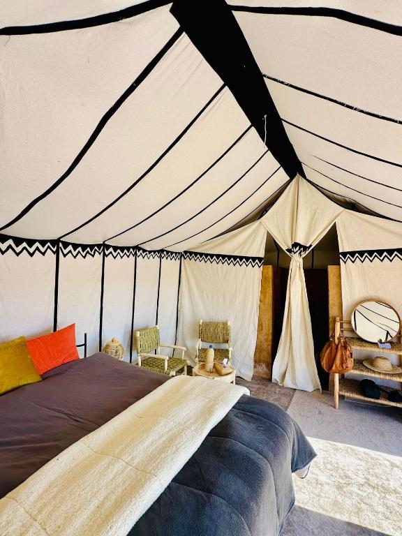 Intricately decorated tents in the Agafay Desert, Morocco, offering luxurious accommodations for stargazing.