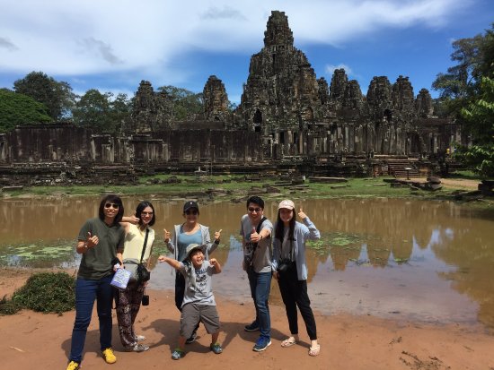 Angkor Wat at sunrise with vibrant green moss