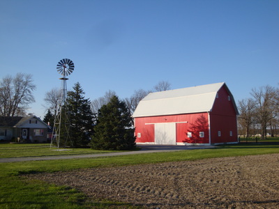 New barn siding installed, showcasing the restored section.