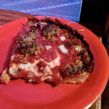 A 'Burnt Rubber' cocktail at Broken Shaker bar, served in a unique glass with a garnish.