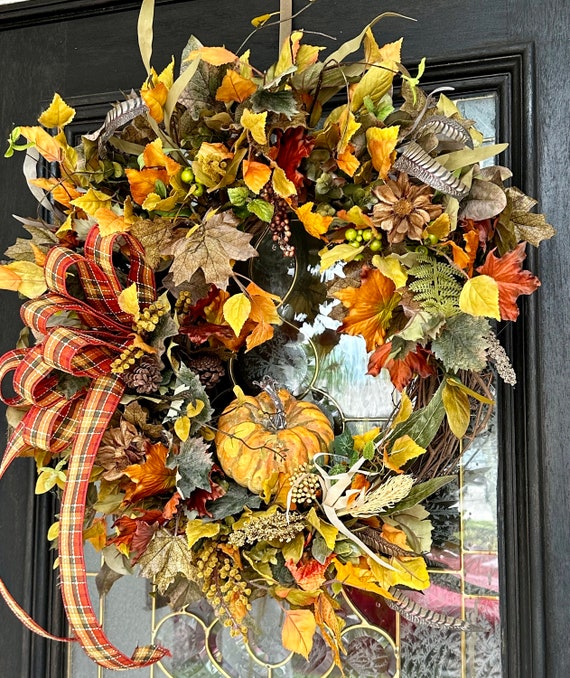 A rustic wooden bench decorated with pumpkins, gourds, and fall foliage, creating a cozy and inviting entryway