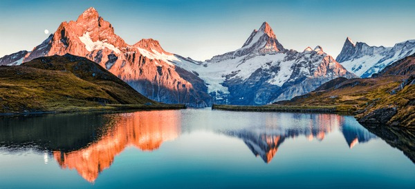 Bachalpsee Lake reflecting the surrounding mountains in the Swiss Alps, creating a picture-perfect scene