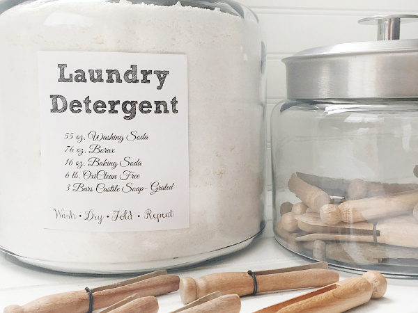 A bottle of white vinegar next to a stack of neatly folded laundry, creating a clean and organized aesthetic.
