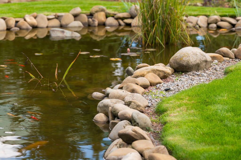 close-up pond liner stone edging installed
