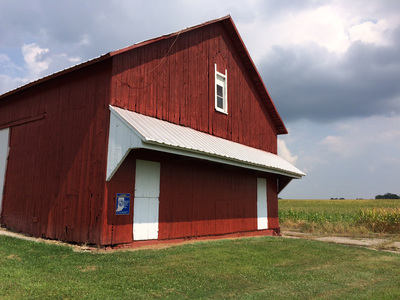 The completed barn siding restoration, blending seamlessly with the existing structure.