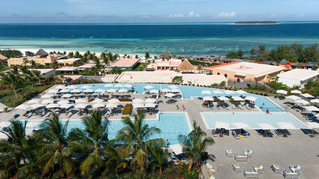 An image showcasing an on-site recycling system at a fictional eco-lodge, highlighting the process of sorting and processing plastic waste.