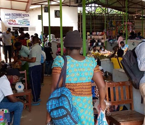 A woman selling Isombe at a local Rwandan market