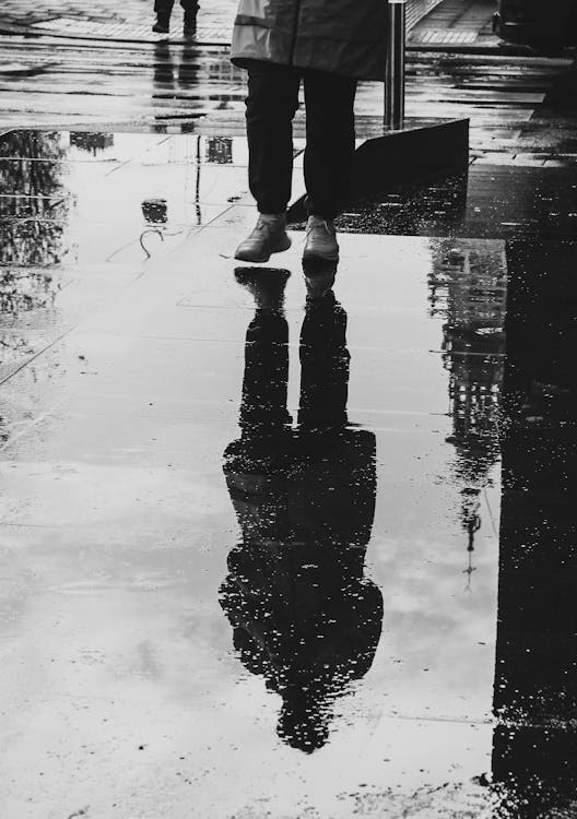 Close-up of someone taking a Frikandel out of a FEBO vending machine, with the illuminated interior visible.