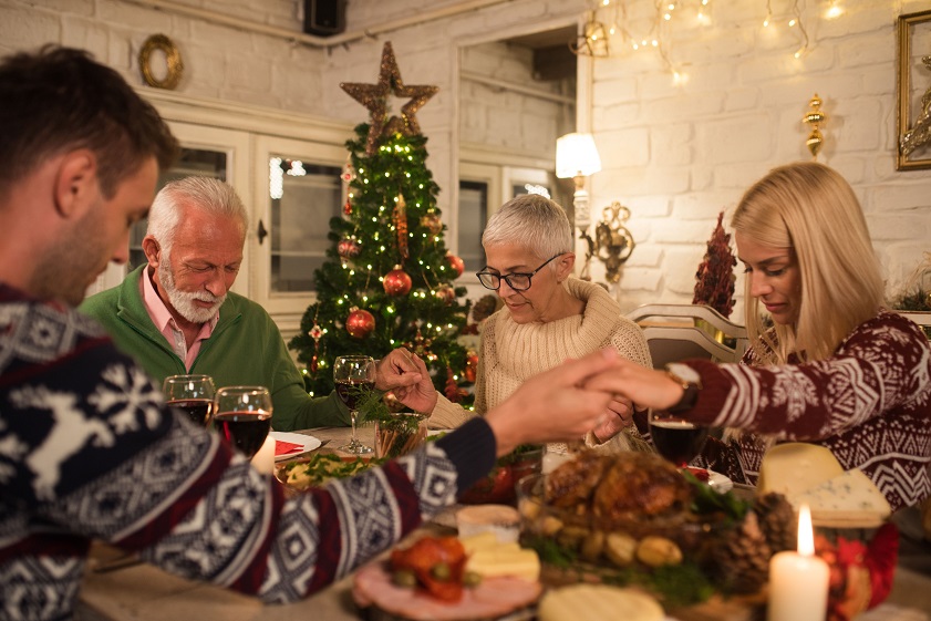 A warm, inviting scene with family gathered around the Julbord, enjoying the feast