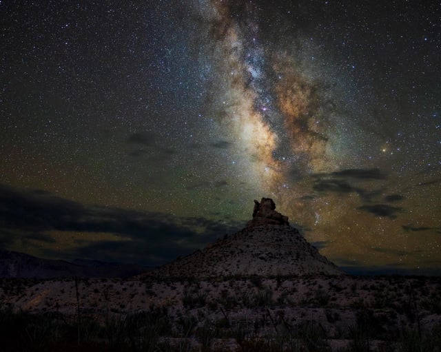 Milky Way arching over the desert landscape at night