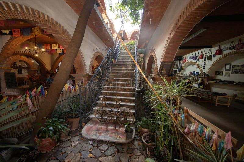 A bustling restaurant scene with people eating and enjoying themselves.