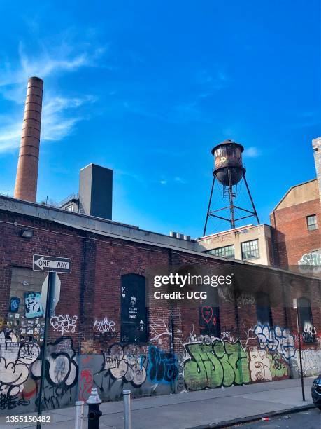 A brightly lit room with desks and people working.
